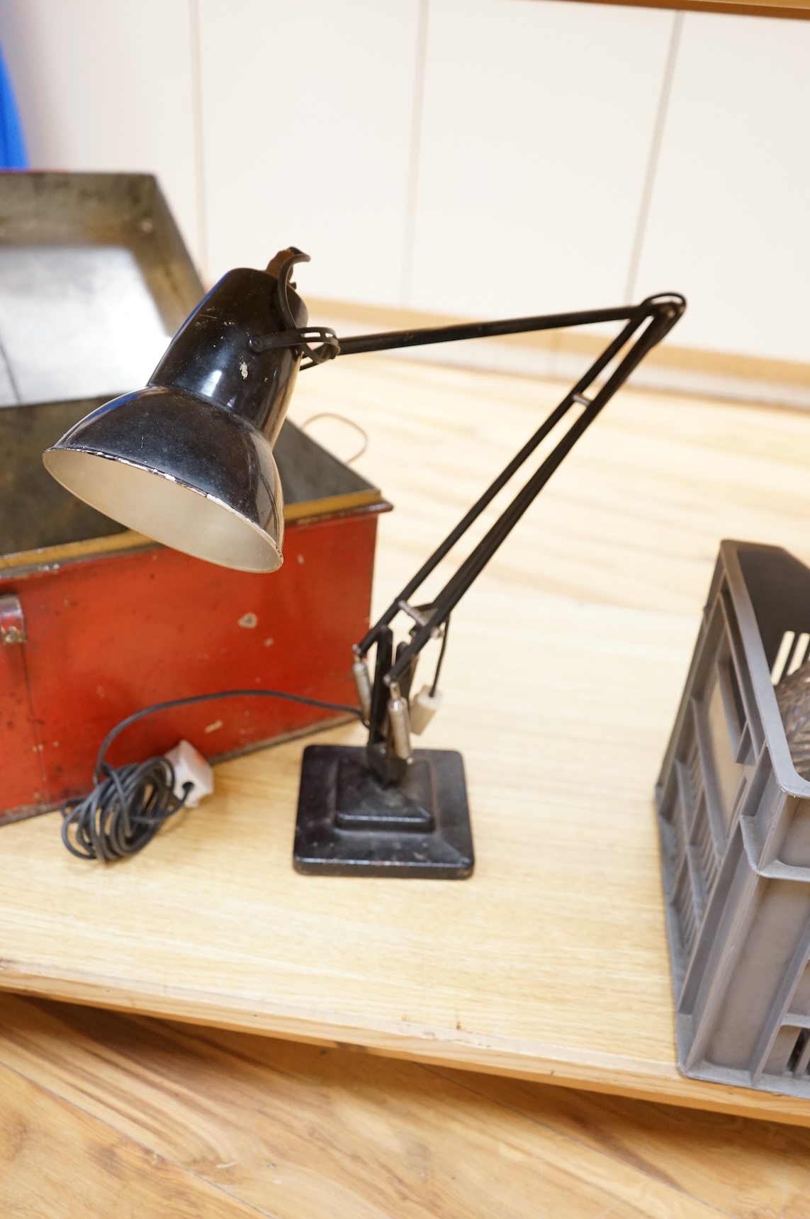 An Anglepoise lamp and metal door furniture and fittings in a tin trunk